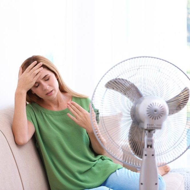 Woman suffering from heat at home